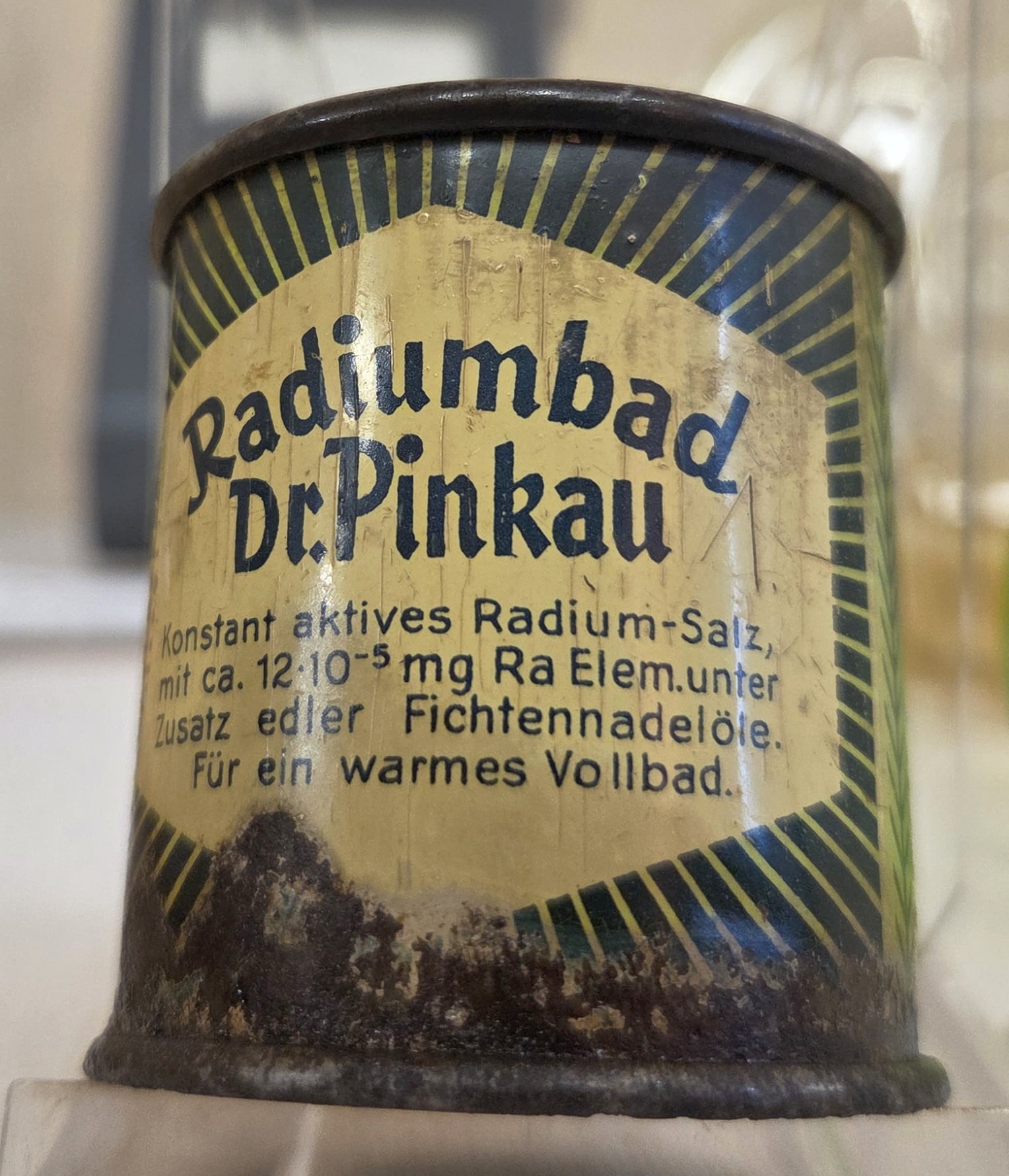 Figure 11 — "Radiumbad Dr. Pinkau" — a German tin of active radium salt sold for a warm full bath, dose printed on the label in milligrams of radium element. The same product idea as the emanator, at grocery s…